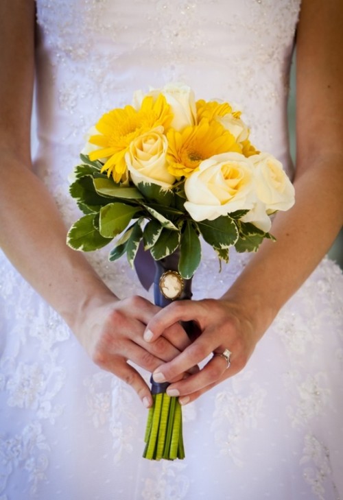a bright yellow wedding bouquet of roses and gerberas plus leaves is a catchy and bright spring wedding idea