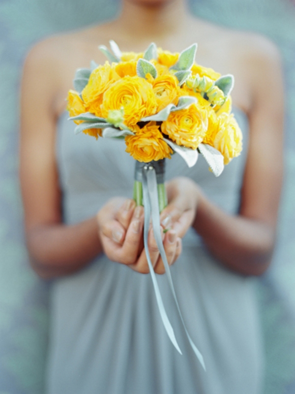 A yellow ranunculus and pale leaf wedding bouquet is a catchy and contrasting idea, suitable not only for brides but also for bridesmaids