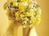 a bright yellow and white wedding bouquet of ranunculus and other smaller blooms will be a fantastic choice for a spring wedding