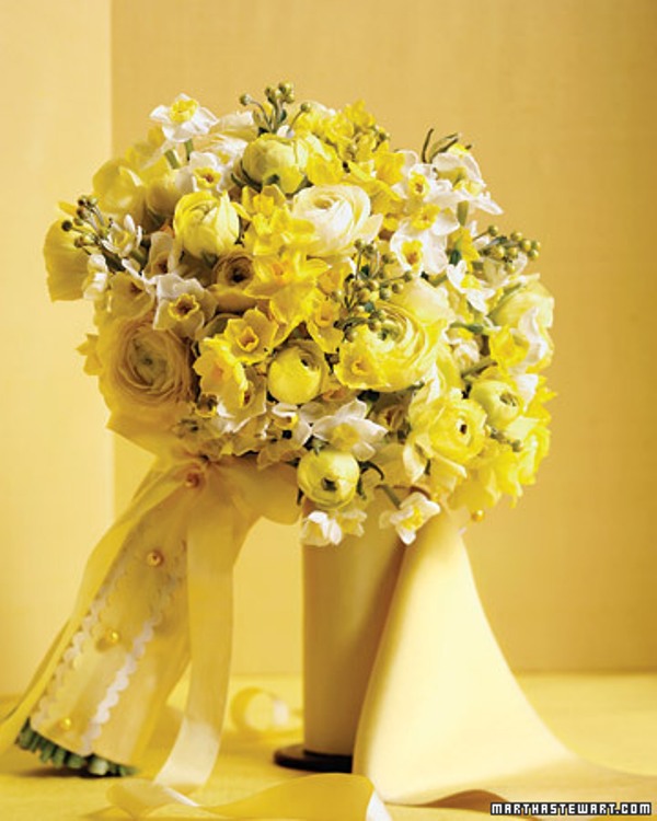 A bright yellow and white wedding bouquet of ranunculus and other smaller blooms will be a fantastic choice for a spring wedding