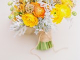 a bold yellow wedding bouquet of ranunculus, pale millet, seed pods with a yarn wrap is a catchy idea for a summer or fall bride