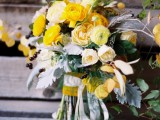 a chic yellow wedding bouquet of peony roses, pale millet, berries is a bold and cool idea for a summer or fall wedding