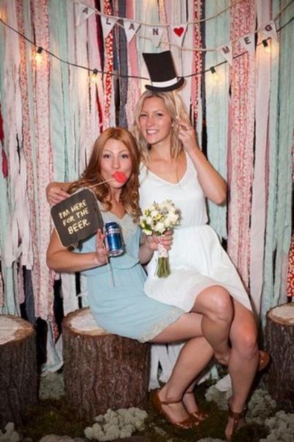 a funny wedding sign and a tall hat prop for whimsy wedding photo booth pics