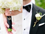 a wedding bouquet with a cute tiny lock pendant and a boutonniere wiht a white bloom and a vintage key for a big day