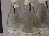 vintage water bottles wrapped with note paper, with tags and vintage keys are served as Love Potion