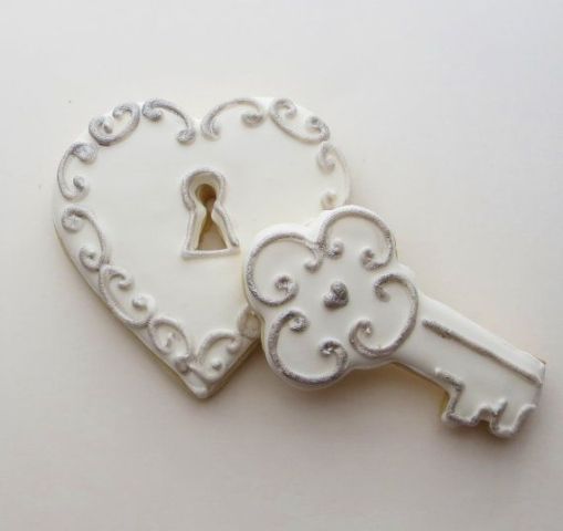 White glazed cookies shaped as a lock and a key are a great idea for a vintage wedding dessert table