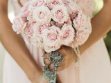 a blush wedding bouquet accented with a vintage key is a lovely idea for a romantic bridal look, with a slight vintage touch