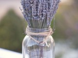 a pretty and easy wedding centerpiece of a jar with lavender and a vintage key on twine is a lovely idea for a Provence-inspired or just rustic wedding