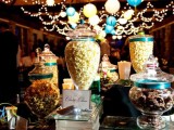 an elegant popcorn bar done with glass jars with lids and signage to mark each type