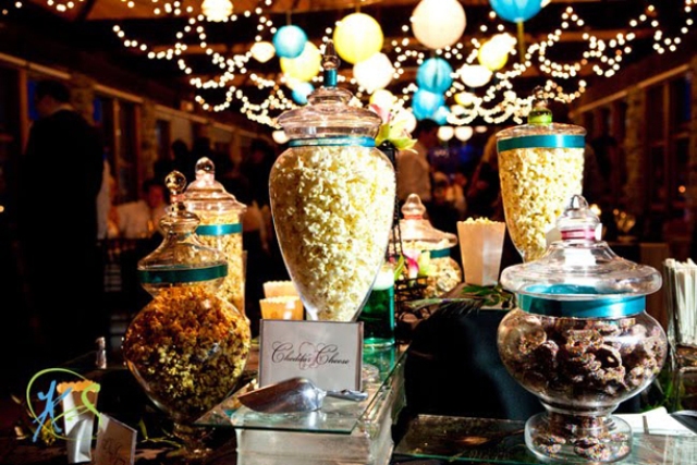 An elegant popcorn bar done with glass jars with lids and signage to mark each type