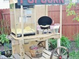 a rustic vintage popcorn bar with a vintage wagon, a popcorn machine, a bucket with popcorn and paper bags to serve it
