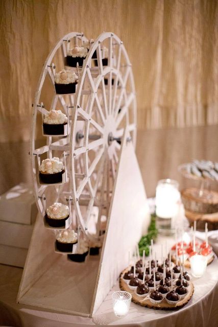 a creative wheel popcorn bar with popcorn bowls on the wheel to rotate and various sweets on the table