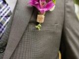 a bright wedding boutonniere of a wine cork piece and bright pink and green blooms looks chic