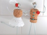 funny cake toppers of wine corks, wire, lace, buttons and fabric blooms can be DIYed by you yourself