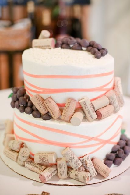 a wedding cake topped with wine corks and grapes will fit a vineyard wedding easily
