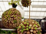colorful wine cork balls hanging over the reception is a fun and cool wedding decor idea