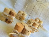 wine corks secured with lace and with stands to hold your couple’s photos and table numbers
