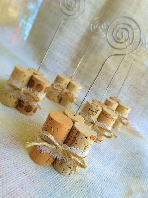 wine corks secured with lace and with stands to hold your couple's photos and table numbers