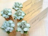 wine corks with fabric blooms and cards are an elegant and chic idea for wedding decor