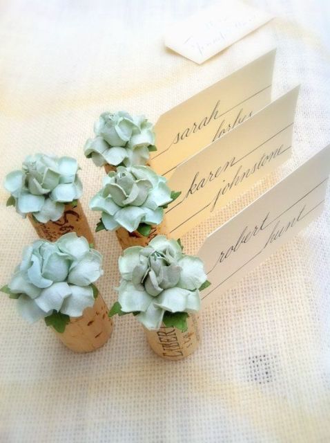 wine corks with fabric blooms and cards are an elegant and chic idea for wedding decor