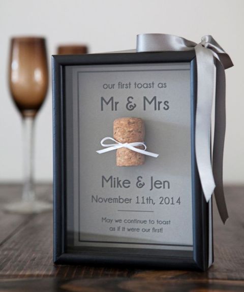 the couple's first toast and a wine cork attached in the frame - a cork from that bottle