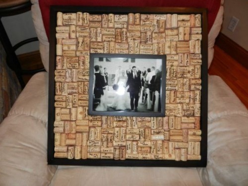 a wedding photo in a frame surrounded with wine corks is a fun and cool vineyard wedding idea