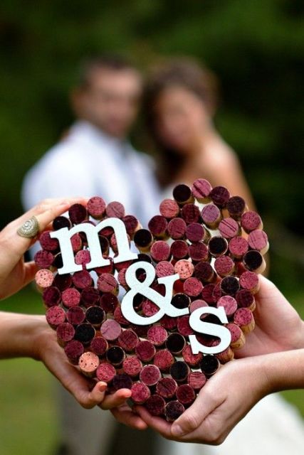 a purple wine cork wedding heart with monograms as a decoration for a bold and cool touch in your venue
