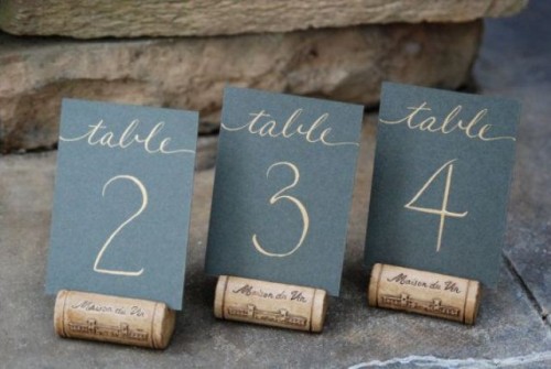 chalkboard table numbers placed on wine corks is a cool and simple idea to go for