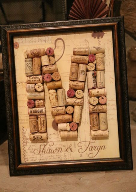 a wine cork monogram in a refined frame is a stylish and easy decoration idea for a vineyard wedding
