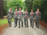 groomsmen wearing grey suits with red ties look very stylish and elegant