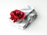 a grey and white chevron clutch with a red bloom for a bride or bridesmaids