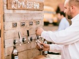 a rustic wedding beer bar with chalkboard marks and faucets for drinks is a very cool and fresh idea to rock