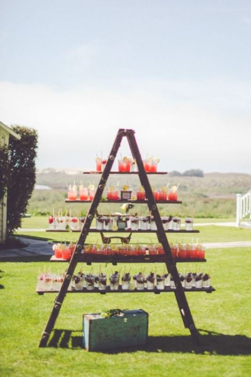 an alternative to a wedding drink bar - a large ladder with various drinks in glasses is a perfect idea for a rustic wedding