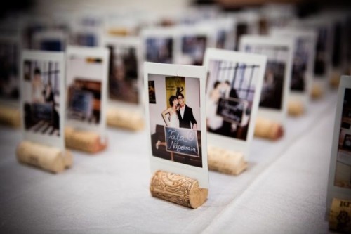 Polaroids put into wine cork stands are a cool idea for weddign escort cards or to spruce up the table decor