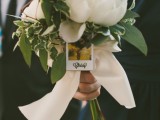 a bridesmaid bouquet with a Polaroid attached to find out where and whose bouquet is