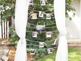 a cute wedding decoration of a frame with curtains and Polaroids hanging on the ropes