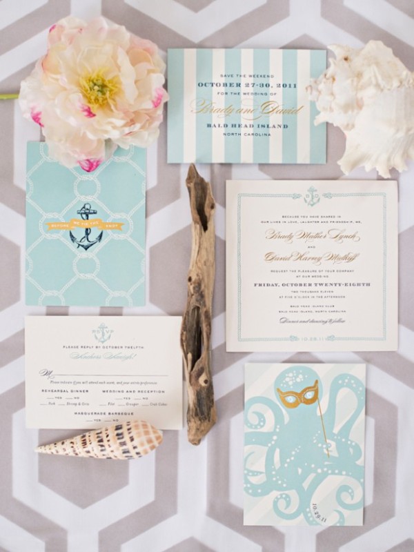 A pretty beach wedding invitation suite with turquoise and white pieces, with stripes, anchors and even an octopus, driftwood and seashells