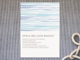 a simple beach wedding invitation with blue, purple and turquoise stripes that feel very beachy and coastal