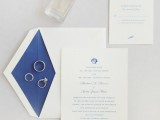 a refined and chic wedding invitation suite in white and navy, with seashell and starfish prints is a classic idea for a nautical wedding, too