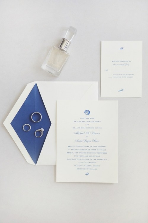 a refined and chic wedding invitation suite in white and navy, with seashell and starfish prints is a classic idea for a nautical wedding, too