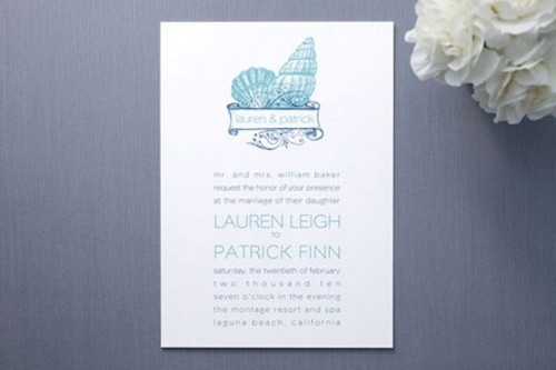 a beach wedding invitation suite with navy and turquoise lettering and seashell prints is a very stylish and bold idea to rock