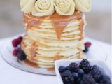 a pancake wedding cake with caramel, fresh berries and white roses is a gorgeous idea for a modern wedding