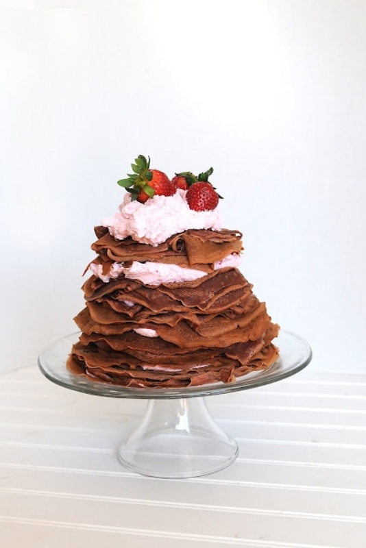 a chocolate crepe wedding cake with cream, strawberries and some pink cream on top is a gorgeous idea for your wedding