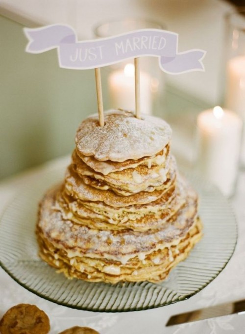 a classy pancake wedding cake with sugar powder and with a catchy paper bunting cake topper is a lovely idea for a small wedding