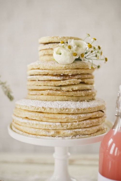 a pancake wedding cake with sugar powder and fresh white blooms is a fab idea for a modern laid-back wedding