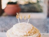 a crepe wedding cake topped with white buttercream, with a tiny gold leaf bunting on top is a cute idea for a tiny wedding