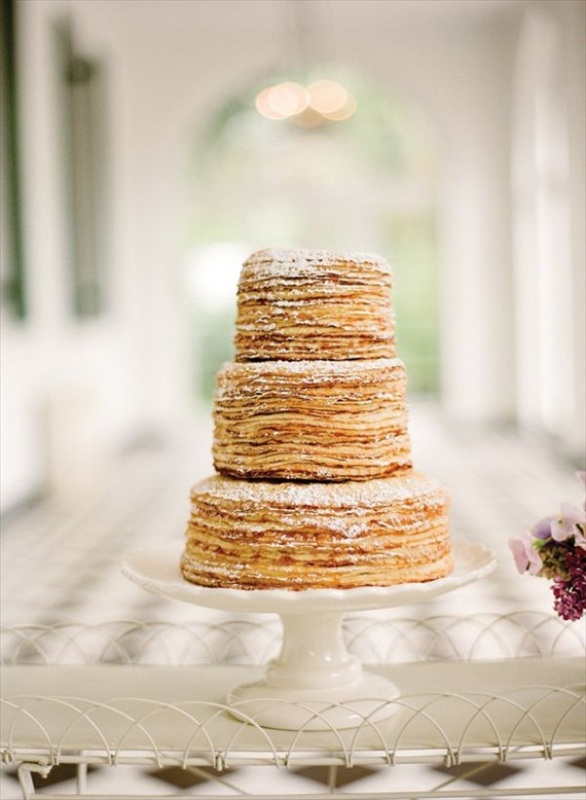 a simple yet refined crepe wedding cake with sugar powder is a lovely idea for a stylish spring or summer wedding