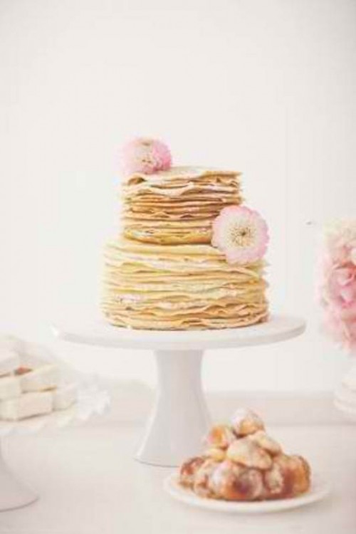 a delicate crepe wedding cake topped with fresh pink blooms is a lovely idea for a sweet pastel wedding in spring or summer