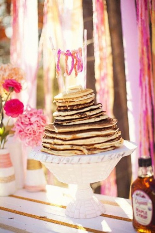 a pancake wedding cake with a pink bunting cake topper is a lovely idea for a relaxed and colorful wedding in spring or summer