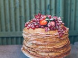 a crepe wedding cake topped with fresh fruit and sugar powder is a gorgeous idea for a summer wedding